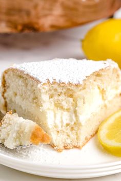 a piece of cake on a plate with lemons