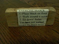 a close up of a wooden table with a sign on it that says exercise block 1 - place block on floor 2 - walk around it twice