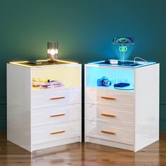 two white drawers with lights on them in a room