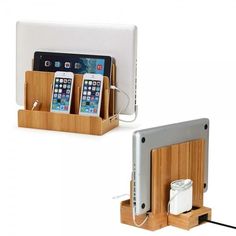 two cell phones are plugged in to the charging station with bamboo holders and cords