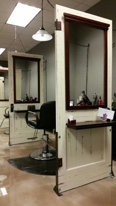 a hair salon with chairs and mirrors in it