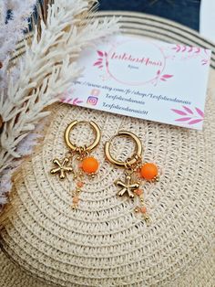 Stainless steel hoop earrings with 18k brass chains and stainless steel flower charm and orange beads Do not fade easily Carefully sent in a tracked letter pouch in a bubble envelope. Everyday Hypoallergenic Orange Earrings, Trendy Handmade Orange Hoop Earrings, Everyday Hypoallergenic Orange Jewelry, Orange Metal Earrings As Gift, Orange Metal Earrings As A Gift, Nickel Free Orange Earrings For Everyday, Nickel Free Orange Hoop Earrings, Orange Hoop Earrings With Ear Wire For Gift, Orange Hoop Earrings With Ear Wire As Gift