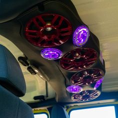 the interior of a vehicle with lights on and wheels hanging from it's ceiling