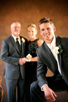 two men and a woman posing for a photo