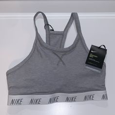 Brand New With Tags Nike Grey And White Training Sports Bra! It Has A Nice Band That Has The “Nike” Print Across It. This Is Such A Great Piece To Have! It’s Super Cute! Size: Small Please Let Me Know If You Have Any Questionsi’m Open To All Offers! Nike Solid Color Sports Bra, Sporty Cotton Sports Bra In Solid Color, Sporty Solid Cotton Sports Bra, Cotton Sporty Sports Bra, Nike Tops With Light Support For Workout, Nike Workout Top With Light Support, Sporty Cotton Sports Bra For Loungewear, Sports Bra With Medium Support For Loungewear, Fitted Cotton Sports Bra