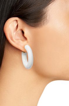 Lightweight enamel hoops in a vibrant hue add a playful vibe to your everyday look. Post back 14k-gold fill Imported Modern Small Hoop White Earrings, Modern White Small Hoop Earrings, Trendy White Enamel Earrings, Summer White Metal Hoop Earrings, Small White Tarnish-resistant Hoop Earrings, Modern White Gold Tarnish-resistant Hoop Earrings, White Enamel Hoop Earrings, White Enamel Small Hoop Earrings, Modern Enamel Hoop Earrings