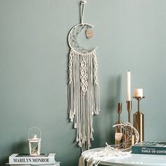 a room with a table, books and a clock on the wall next to it