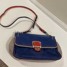 This Vintage Bag Is The Perfect Pop Of Color For Summer! It Has A Distressed Leather Exterior And Striped Interior With Silver Accents. The Inside Has Several Functional Pockets And Compartments With Secure Clasp Closure On The Front Of The Bag. Designer Blue Satchel With Adjustable Strap, Coach Crossbody Bag With Magnetic Closure, Designer Blue Clutch Shoulder Bag, Blue Leather Bag With Magnetic Closure, Blue Leather Bags With Magnetic Closure, Designer Blue Coach Shoulder Bag, Designer Blue Shoulder Bag For On-the-go, Designer Blue Shoulder Bag, Coach Multicolor Clutch Bag