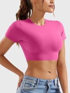 This adorable super-cropped top is designed to enhance your body proportions with a flattering fit. The double-layer lining ensures opacity, making it a versatile wardrobe essential for fitness, yoga, and casual outings.   Feature     Super Cropped Length  Short sleeve, breathability, and comfort  Double-lined, anti-see-through  Skin-friendly for body shaping  Versatile for any occasion     Fabric    73% Nylon + 27% Spandex    Model Measurements    Model Wear: S   Height: 173cm / 5'7"   Bust: 87 Trendy Tops With Built-in Bra And Medium Support, Pink Crop Top With Built-in Bra, Spring Cropped High Stretch Activewear, Spring High Stretch Cropped Activewear, Spring Versatile Cropped Activewear, Cropped High Stretch Spring Activewear, Trendy Cropped Activewear For Spring, Fitted Cropped Activewear For Spring, Spring Activewear Crop Top With Built-in Bra