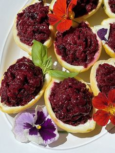 several pieces of bread with cranberry toppings on them and flowers in the background