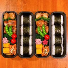 three bento boxes filled with sushi and vegetables