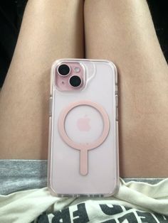 an iphone case with a magnifying glass on the back of it, sitting on someone's lap