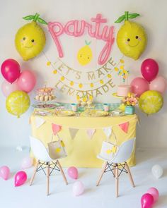 a party with lemons and balloons on the wall