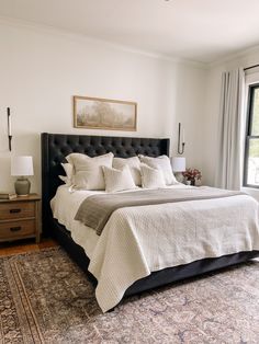 a bedroom with a bed, rug and window