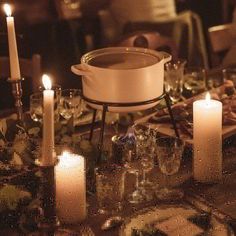 a table with candles and dishes on it