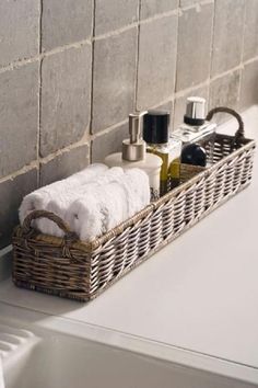 a wicker basket with towels and soaps on it