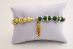 The Saint Jude's Good Fortune Protection Bracelet is a symbol of good luck, prosperity, and protection when it's worn on the wrist. This strong and powerful bracelet not only has a Saint Jude medallion but also has green, yellow, and white crystal beads to bring more good luck and fortune into your life. It's perfect for people of all faiths and traditions. Saint Jude is the Patron of Lost Causes. This protection bracelet with meditation beads will empower your mind, body, and soul. With healing Green Spiritual Stretch Bangle Bracelet, Green Spiritual Bracelets For Gift, Green Jubilee Bracelet As A Gift, Green Jubilee Bracelet Perfect As A Gift, Adjustable Green Spiritual Rosary Bracelet, Symbolic Adjustable Green Bracelets, Spiritual Green Charm Bracelet For Gift, Spiritual Green Charm Bracelet Gift, Green Adjustable Symbolic Bracelets