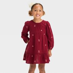 Add an elegant piece to your toddler's wardrobe with this Floral Long-Sleeve Dress from Cat & Jack™. This long-sleeve dress in a knee length sports a casual crewneck, soft gathers on the waist, a tiered hem and allover floral embroidery for cute style. The soft cotton gauze fabric with lining lends comfortable all-day wear, and the keyhole behind-the-neck button closure makes dressing easy. Plus, the side pockets provide space for them to stash their favorite small toys. Cat & Jack™: Designed fo Girls Chambray Dress, Floral Long Sleeve Dress, Toddler Dresses, Girls Tunics, Cozy Dress, Cami Maxi Dress, Small Toys, Target Clothes, Color Palate