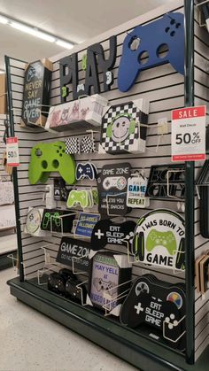 there is a game store display with video games on the shelves and other items for sale