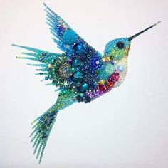 a beaded hummingbird flying in the sky