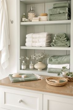 towels are stacked on shelves in the bathroom