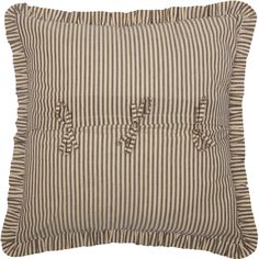 a brown and white striped pillow with ruffles on the front, one side