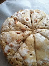 a close up of a doughnut on a piece of wax paper with nuts in it