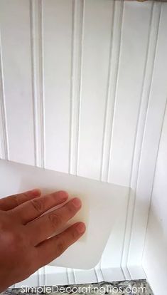 a hand holding a piece of white paper