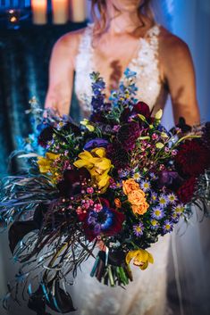 a bride holding a bouquet of flowers in her hands at the end of their wedding day