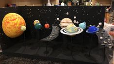 the solar system is displayed on display in a museum case with other items around it