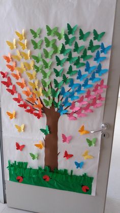 a door decorated with paper butterflies and a tree