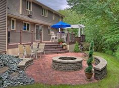 a fire pit in the middle of a brick patio