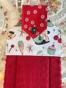 two red towels sitting next to each other on top of a doily covered table