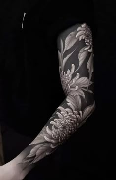 the arm is covered with black and white flowers, while it's full sleeve