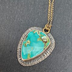 "Didn't It Break Your Heart" This colorful Treasure Mountain Turquoise is set in fine and sterling silver, stamped and double-layered, accented with 18k gold jump rings. Oxidized and tumbled for a dark satin finish. Pendant measures approximately 36mm tall x 27.5mm wide. Necklace is sterling silver and gold filled rolo chain, measuring 18" with an additional 1.6" extension chain. Sterling silver lobster clasp. Turquoise Pendant Necklace, Southwest Jewelry, Rolo Chain, Turquoise Pendant, Jump Rings, Gold Filled, 18k Gold, Turquoise, Pendant Necklace