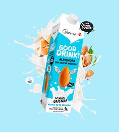 a carton of good drink with almonds and milk splashing out of it