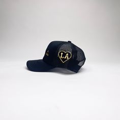 In LA we believe in hospitality. This is our universal way of saying "WELCOME". 100% PolyesterSpot clean with distilled soapy water.Trucker hat. One size fits all. Novelty Black Trucker Hat One Size, Personalized Black Trucker Hat, Black 5-panel Trucker Hat For Beach, Black Six-panel Trucker Hat With Logo Patch, Black Military Trucker Hat, One Size Fits All, Black