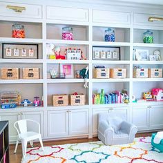 a living room filled with lots of white shelves