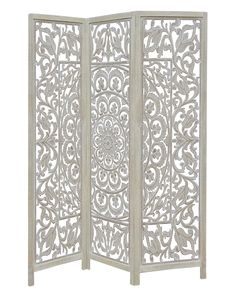 a white room divider with an intricate design on the top and bottom panel,