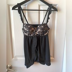 - New With Tags - Black Open Front Babydoll Nightie Top - Built In Lace Underwire Bra With Light Pink Lining - Size 34b - Adjustable Staps - Underwire Bra - 90% Modal / 10% Elastane - Does Not Come With The Matching Panties Coquette Chemise With Built-in Bra For Night, Black Lace Camisole In Flirty Style, Black Lace Camisole In Feminine Style, Black Lace Coquette Camisole, Victoria's Secret Lace Sleepwear With Built-in Bra, Lace Sleepwear With Built-in Underwire Bra, Black Lace Sleepwear For Loungewear, Black Sheer Camisole Sleepwear, Black Lace Nightgown With Lace Trim