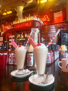 two chocolate milkshakes with pink wafers and red striped straws sitting at a 50s themed bar counter. red neon lights on the wall behind cast a red glow Date Chocolate, Date Shake, 1950s Diner, American Cafe, Milkshake Bar, 50s Diner, Diner Recipes