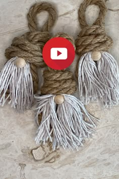 the rope is tied up with two wooden pegs and one has a red button on it