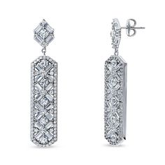 These art deco bar dangle earrings are the epitome of vintage inspired elegance featuring mesmerizing geometric patterns.  Crafted with sterling silver, rhodium plated, stamped 925, nickel free. Set with premium quality 5.54 carat total baguette and round cubic zirconia in pave and prong setting. Earrings measure 1.85" in length, 0.4" in width. Posts with butterfly backs. Deco Bar, Art Deco Bar, Vintage Inspired Art, Ashes Jewelry, Bar Art, Statement Art, Silver Bar, Cubic Zirconia Earrings, Cz Earrings