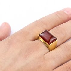 Metal: 14k Yellow Gold Agate: 1.3cm x 1.8cm (0.5" x 0.7") shape - Rectangular cabochon setting type - Bezel setting Product weight: 10.0 gr While you may not be royalty, you'll feel like a king for the day when you sport this ring! This rugged piece features a Rectangular shaped red agate perfectly set in a sparkling 14k yellow gold. A regal masterpiece! ---------------------------------------------------------------------- Agate Agate derives its name from the Greek "Agate" - happy. According t Mens Diamond Ring Designs, Luxury Classic Men's Agate Ring, Luxury Classic Agate Men's Ring, Luxury Agate Men's Ring, Red Oval Cabochon Gemstone Signet Ring, Luxury Red Agate Men's Ring, Mens Diamond Ring, Rich Style, Diamond Rings Design