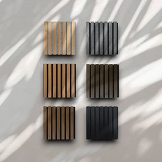 four different types of wooden slats on a white wall with shadow from the sun