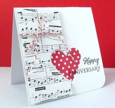 a handmade card with music notes and a red heart on it that says happy anniversary