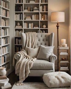 a living room filled with lots of bookshelves next to a chair and ottoman