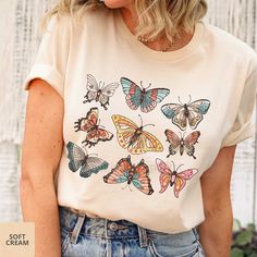 Pretty shirt for butterfly/nature/garden lovers! - Choose color from drop-down menu. - Unisex sizing. Please reference size chart, keeping in mind that the sizing table only contains measurements for one side of the garment, not the circumference. Choose size from drop-down menu. - Please allow 7-10 business days for processing and shipping. -Bella and Canvas Tees are a buttery-soft cotton/cotton blend shirt with rib-knit collars and sloped shoulders to bolster shaping. Our designs are printed with water-based, non-toxic, odorless ink. - Care Instructions Items should be washed inside out in cold water without bleach, dry cleaning, or ironing directly on the pattern. - Returns Because the design is printed specially for you, we can not accept returns. However, if there's an issue with your Cute Butterfly Print T-shirt For Spring, Cute Summer T-shirt With Butterfly Print, White Butterfly T-shirt For Spring, Summer Cotton T-shirt With Butterfly Sleeves, Casual Green Top With Butterfly Print, Spring Butterfly Graphic Print Top, Cute Spring Butterfly Print T-shirt, Cute Butterfly Print T-shirt For Summer, Cute Butterfly Print Summer T-shirt