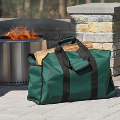 a green bag sitting next to a fire pit