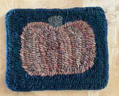 a blue rug with an apple on it